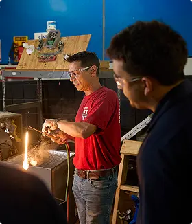 Instructor demonstrating HVAC skills to students